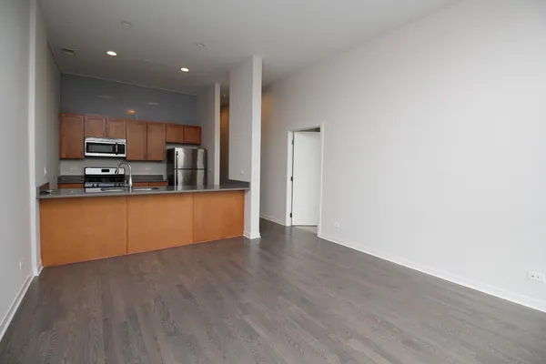 a kitchen with stainless steel appliances a refrigerator and a stove top oven