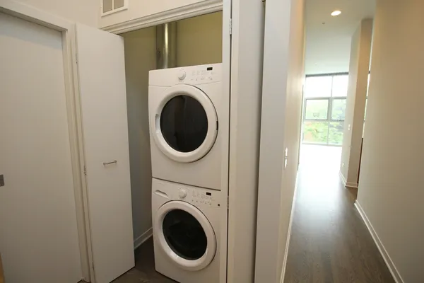 a view of a hallway with washer and dryer