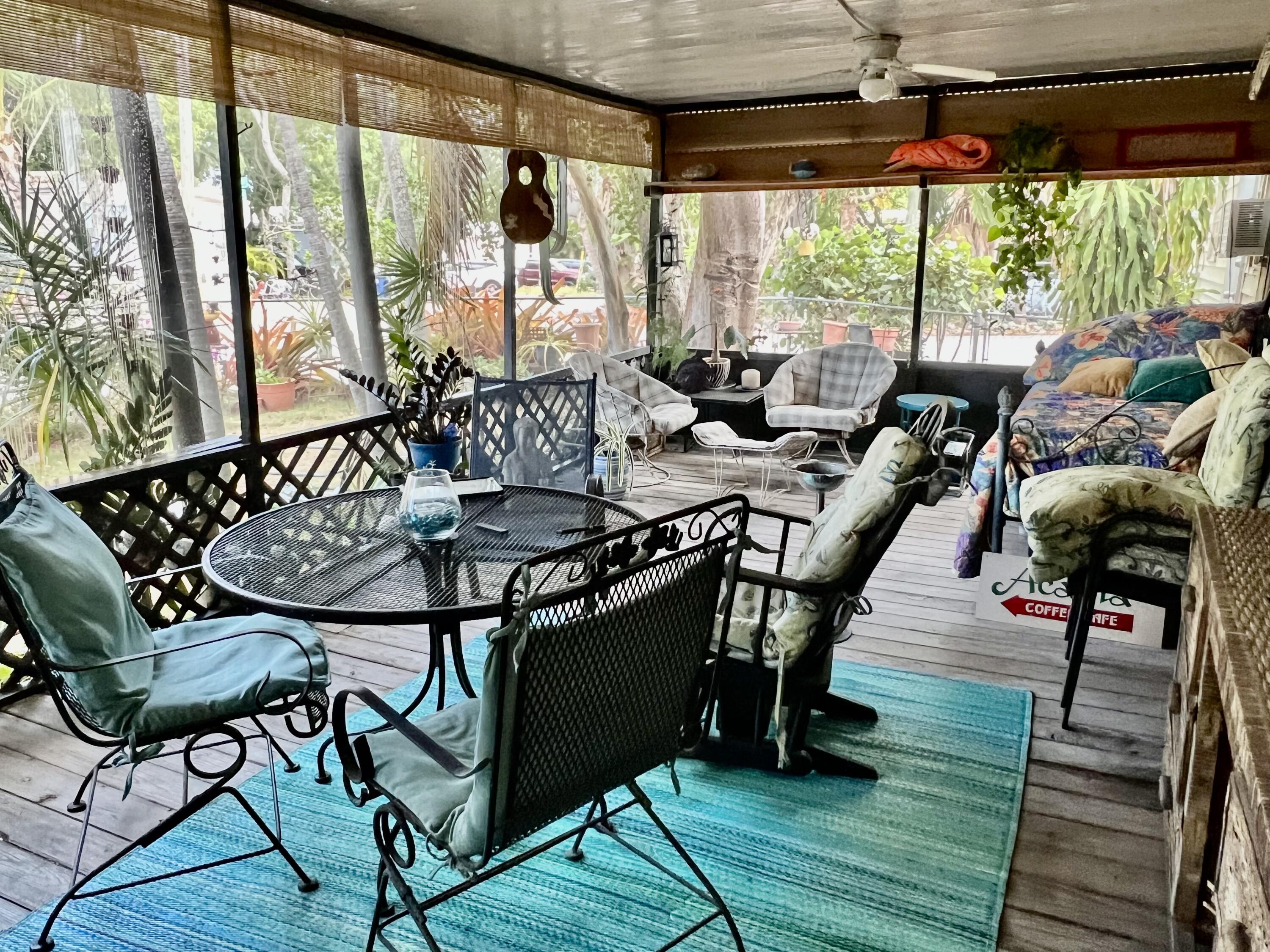 702 Largo Road Key Largo, FL 33037 - Photo 12 of 19 a view of a chairs and table in the patio