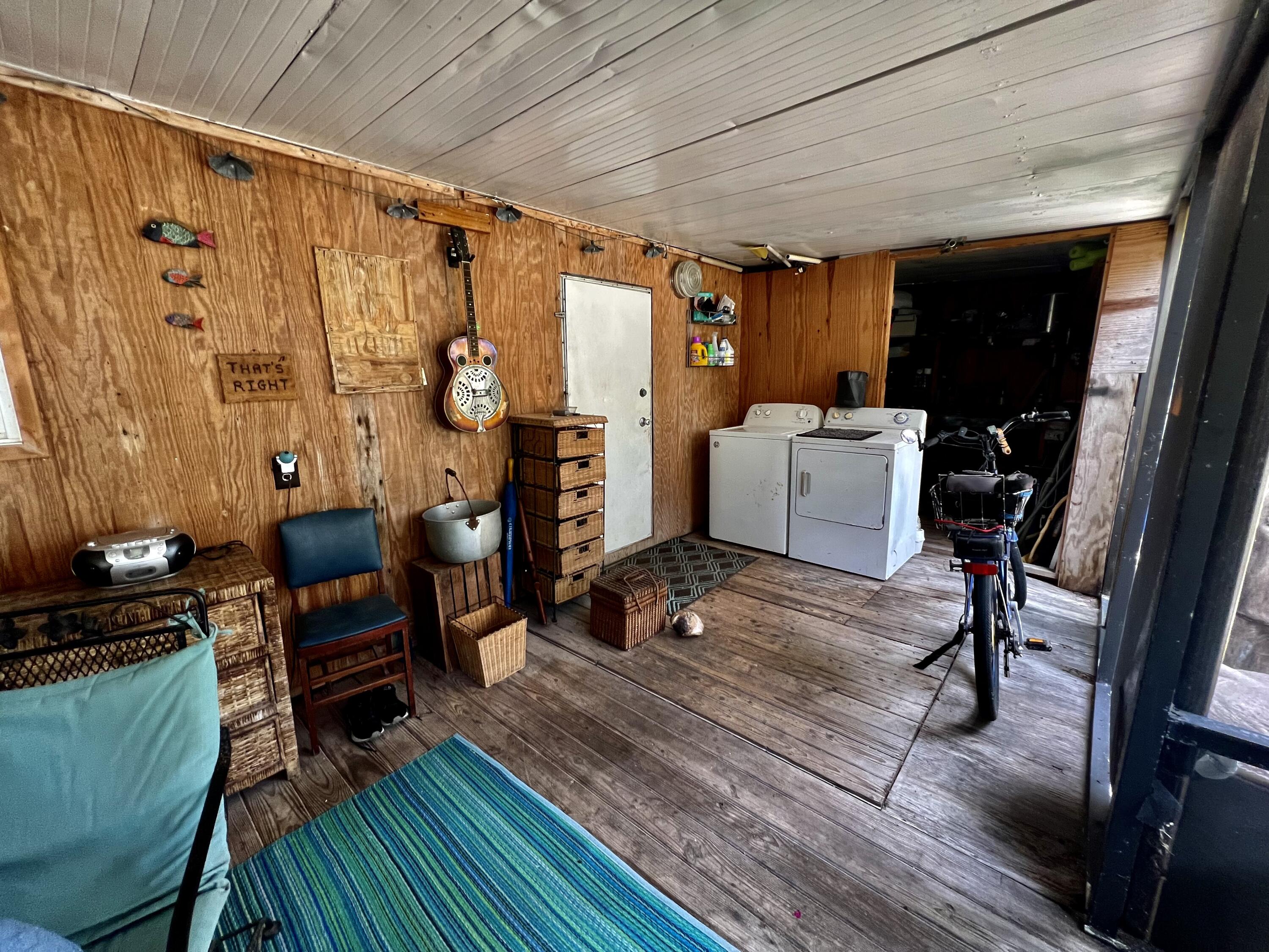702 Largo Road Key Largo, FL 33037 - Photo 13 of 19 a living room with furniture and a flat screen tv