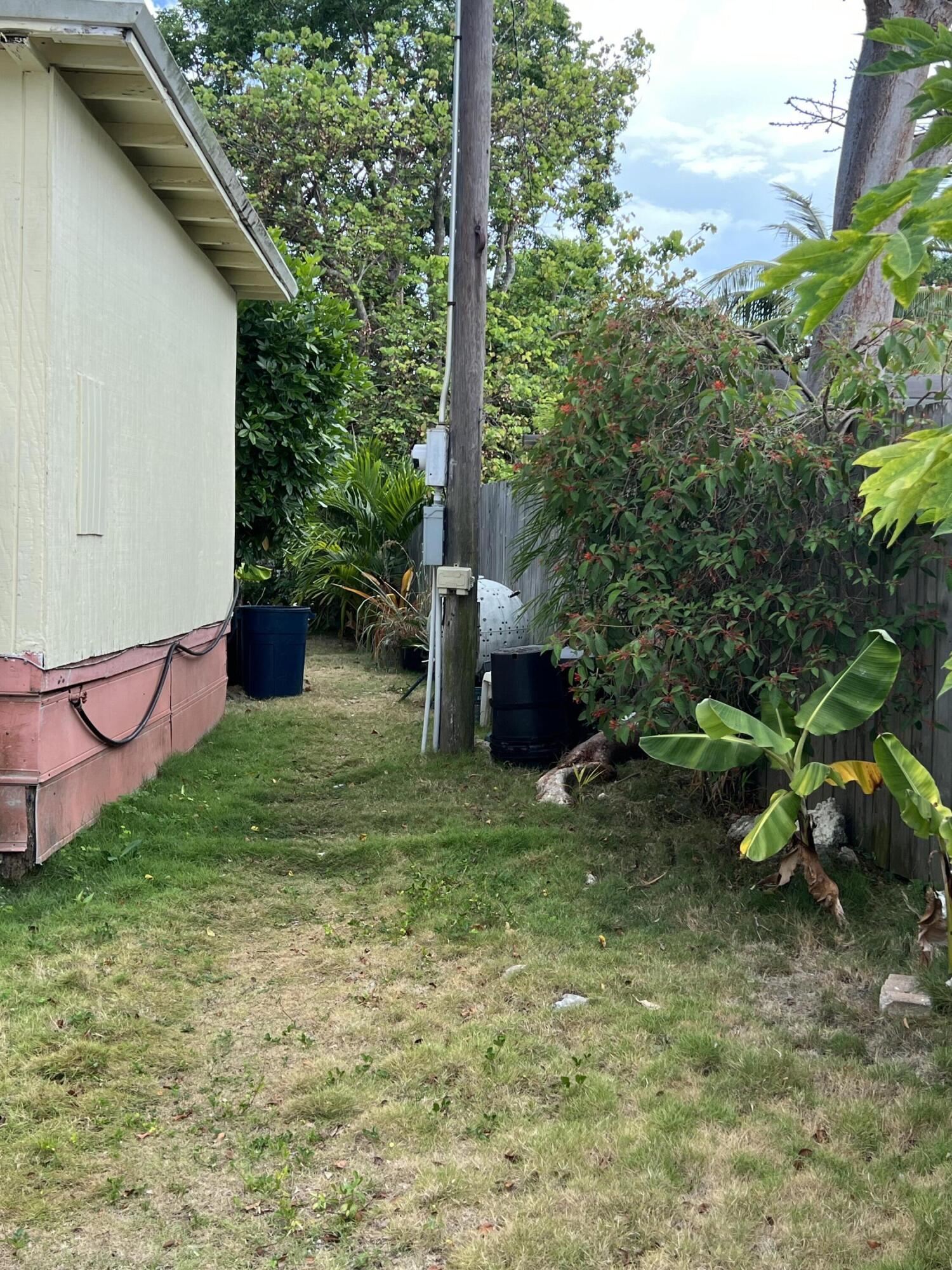 702 Largo Road Key Largo, FL 33037 - Photo 16 of 19 a backyard of a house with lots of green space
