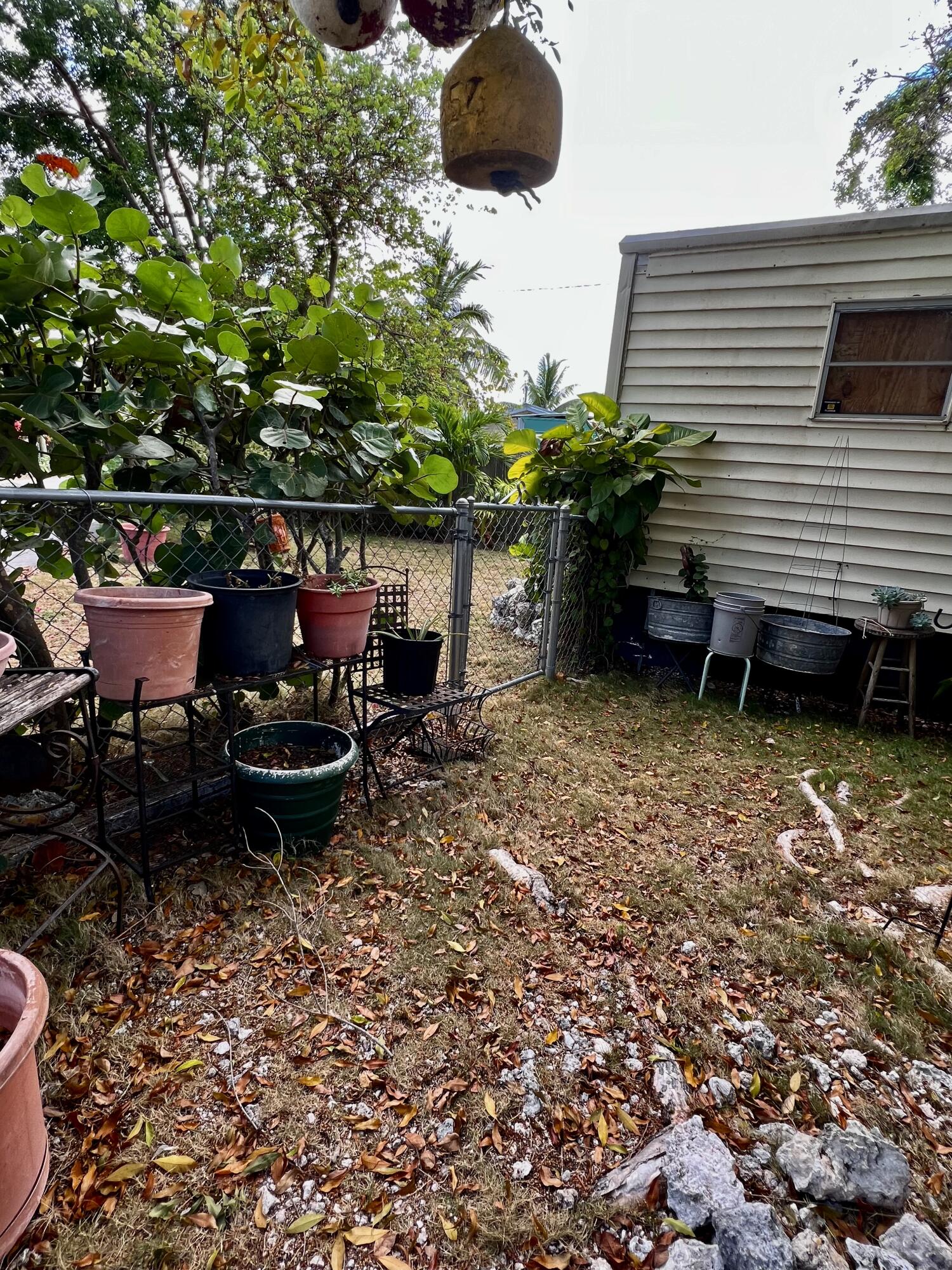 702 Largo Road Key Largo, FL 33037 - Photo 18 of 19 a backyard of a house with table and chairs