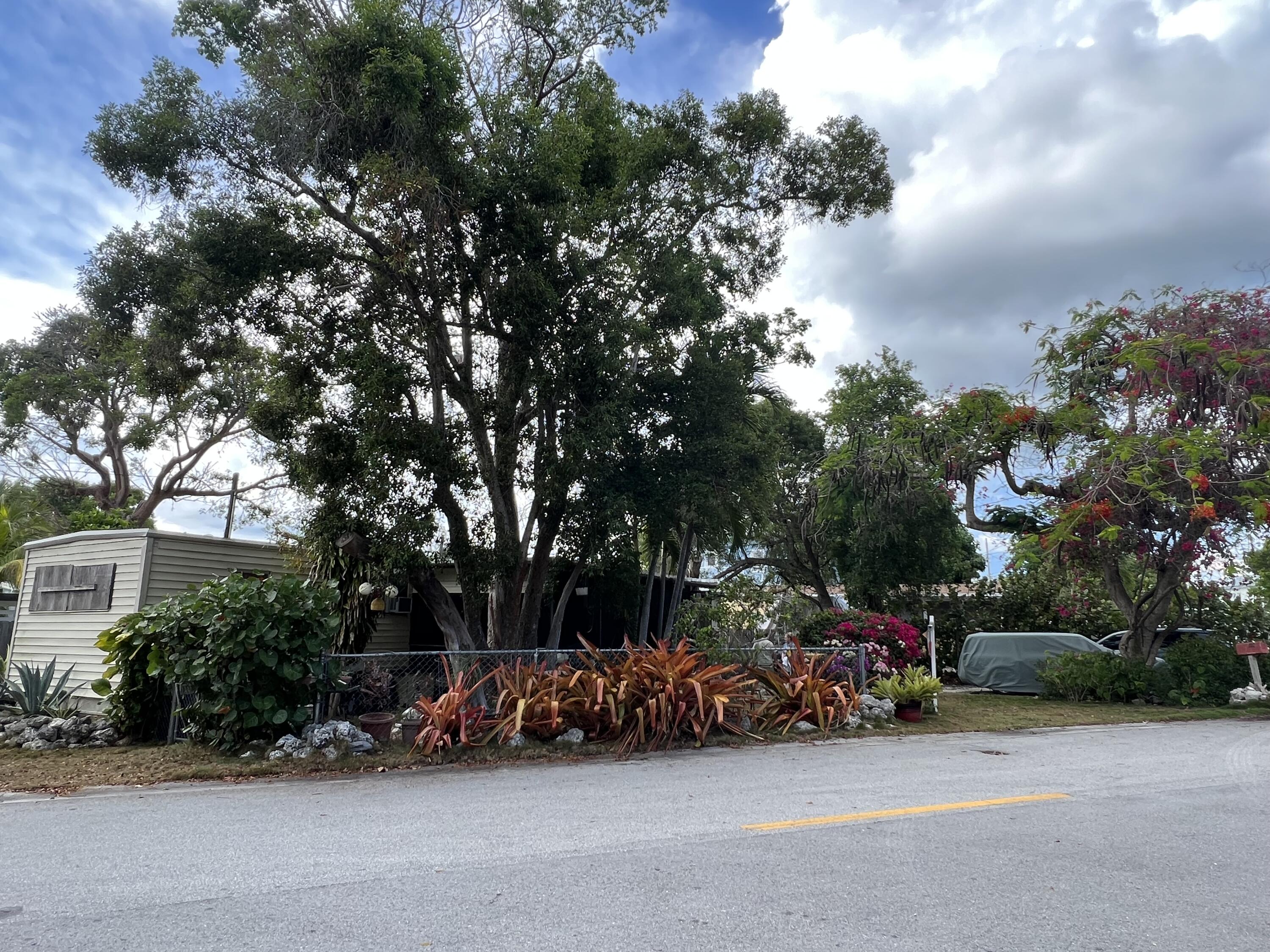 702 Largo Road Key Largo, FL 33037 - Photo 2 of 19 a view of a parked cars in front of a house