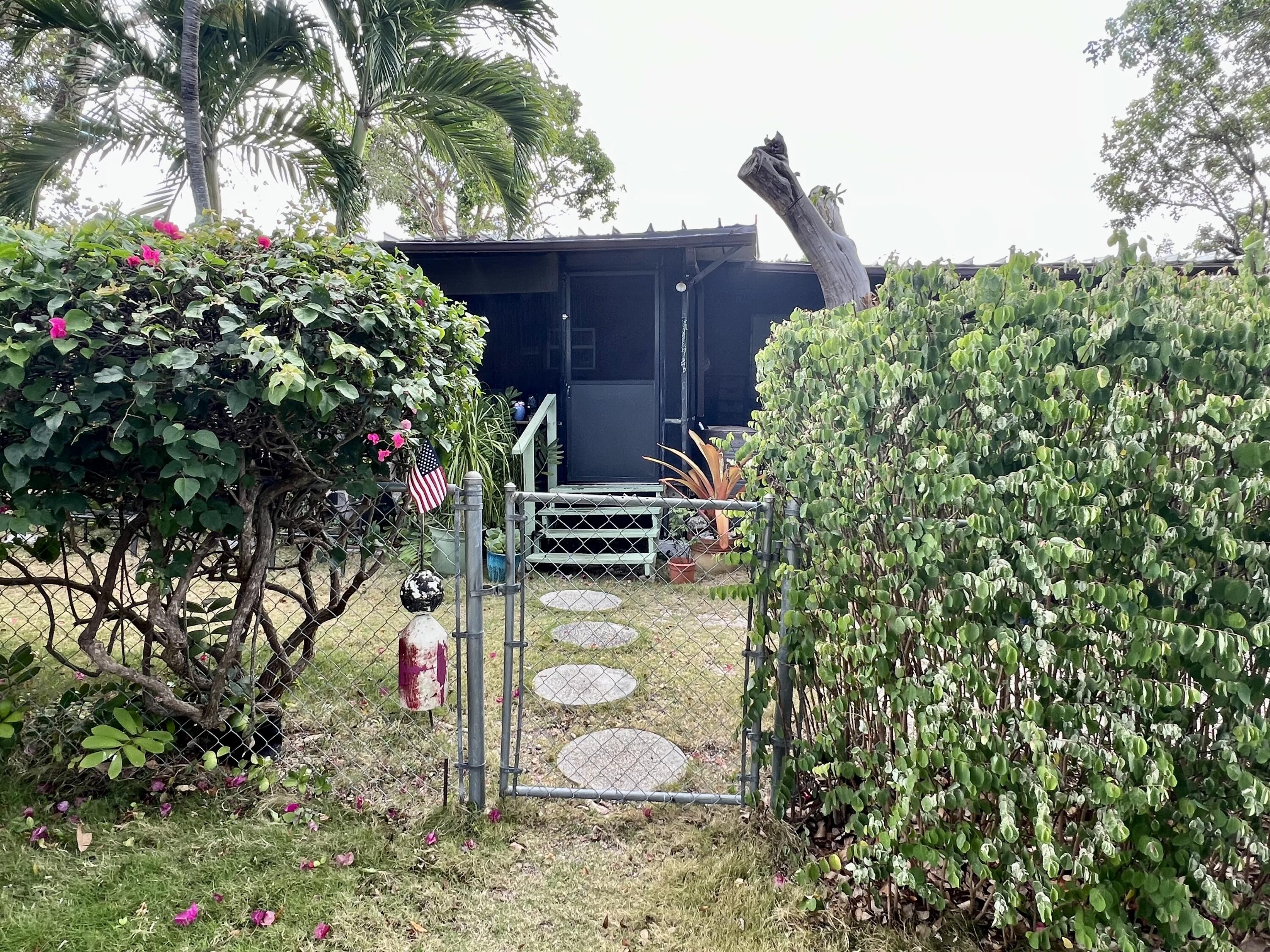 702 Largo Road Key Largo, FL 33037 - Photo 4 of 19 a backyard of a house with lots of green space