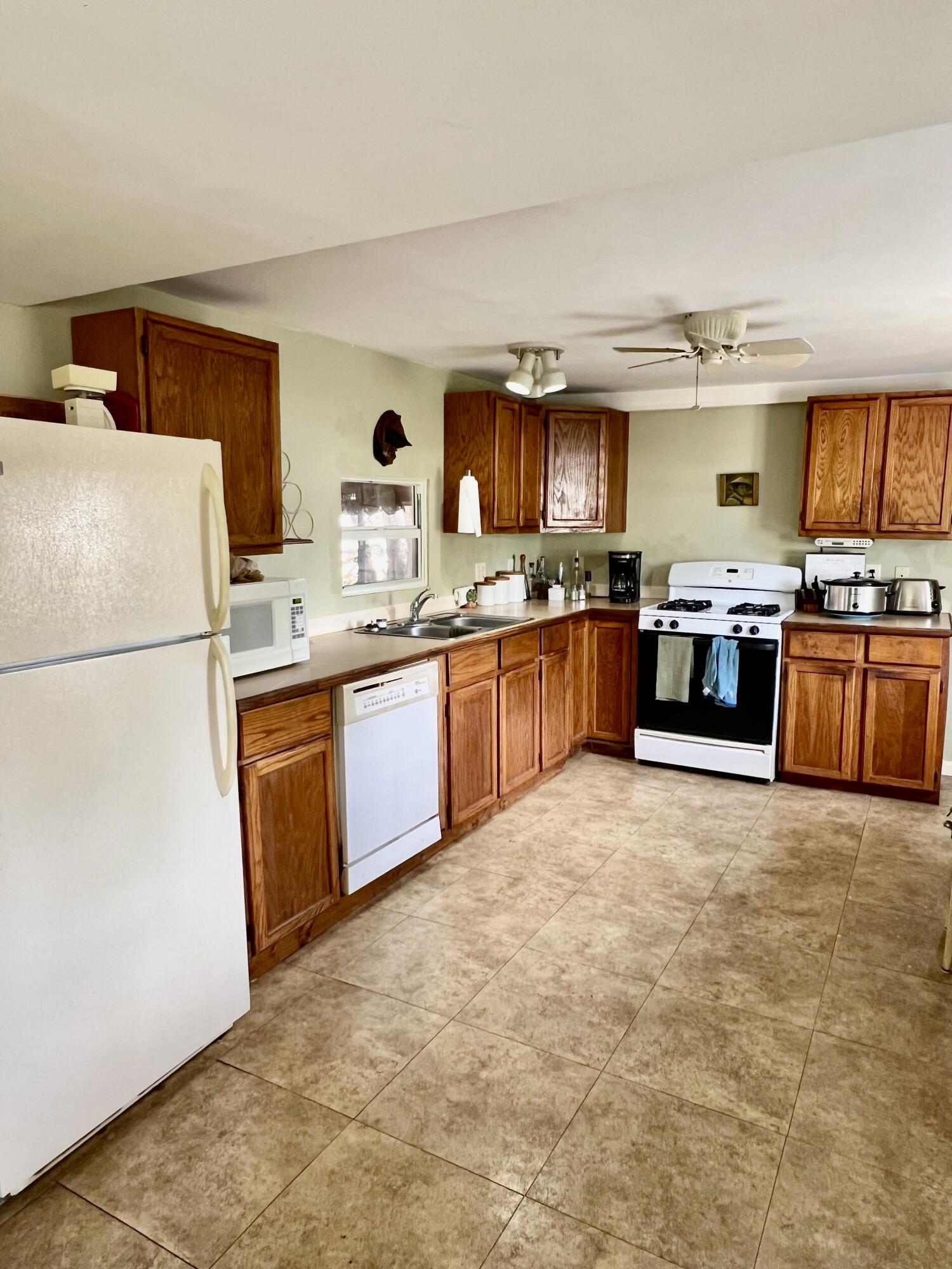 702 Largo Road Key Largo, FL 33037 - Photo 5 of 19 a large kitchen with cabinets and stainless steel appliances