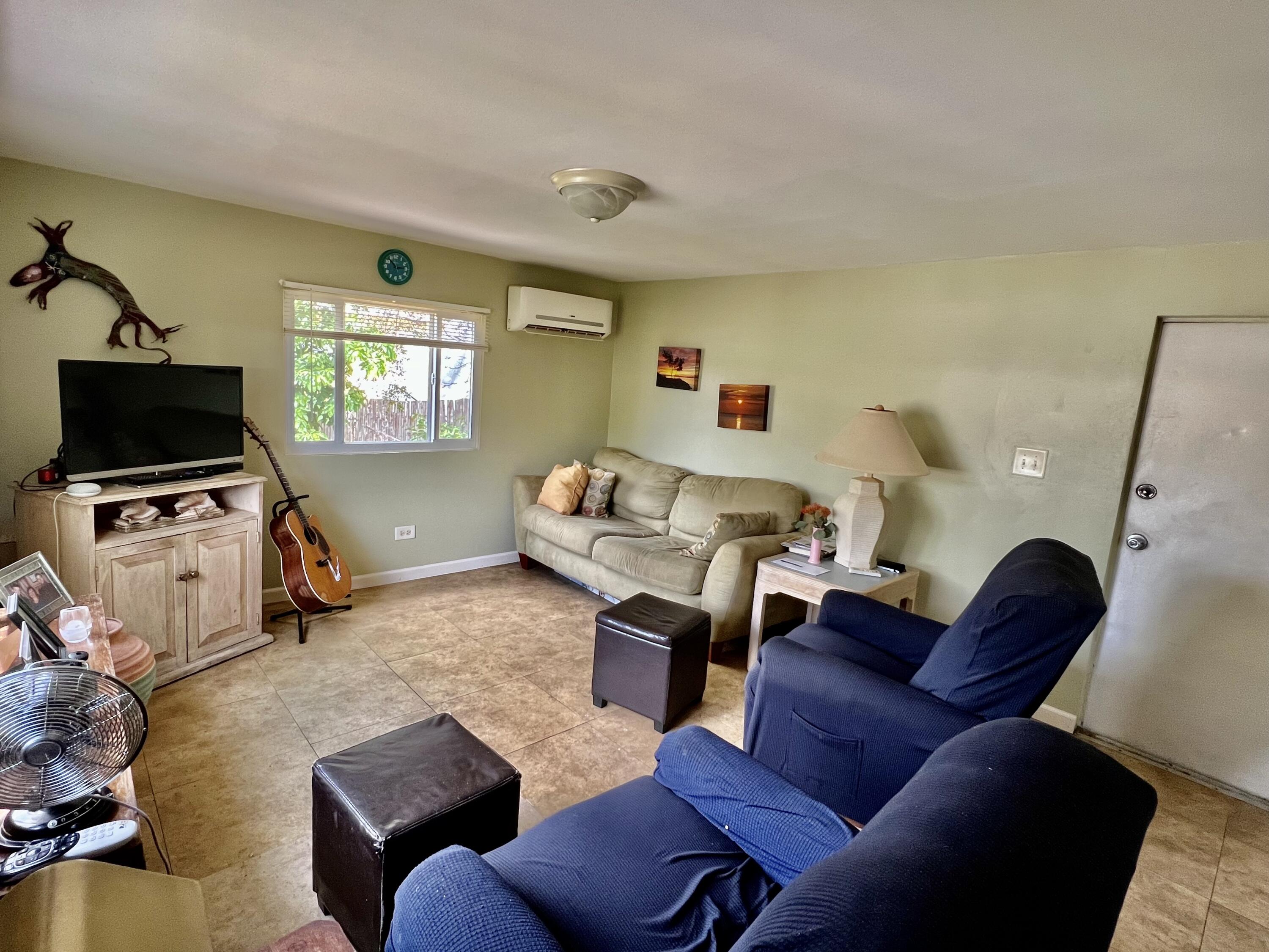 702 Largo Road Key Largo, FL 33037 - Photo 6 of 19 a living room with furniture a flat screen tv and a window