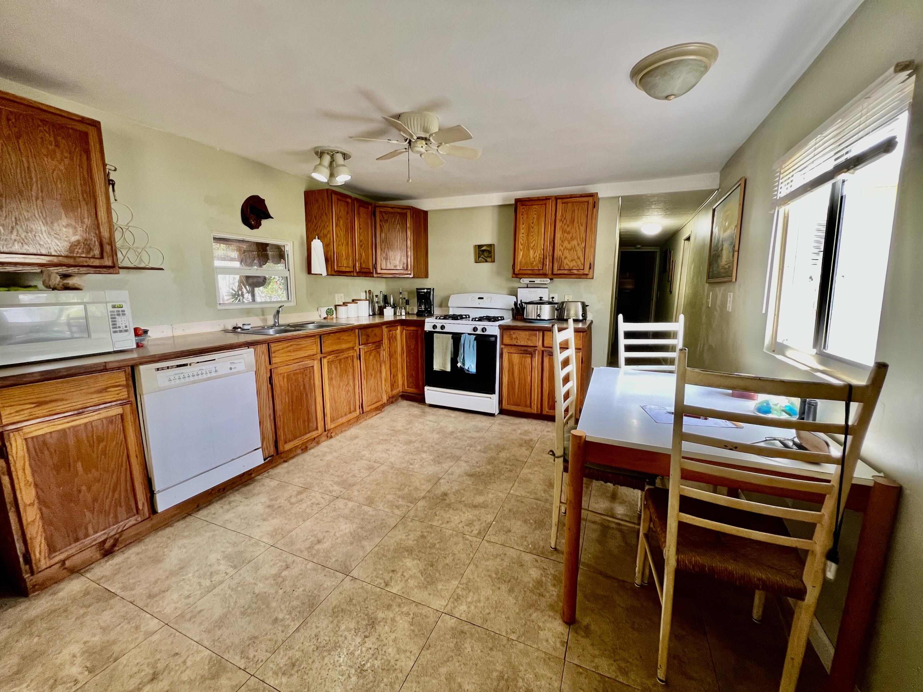 702 Largo Road Key Largo, FL 33037 - Photo 7 of 19 a large kitchen with cabinets table and chairs