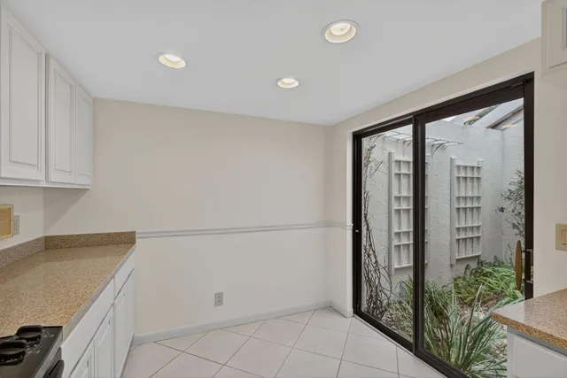 a view of a kitchen cabinets and an empty room