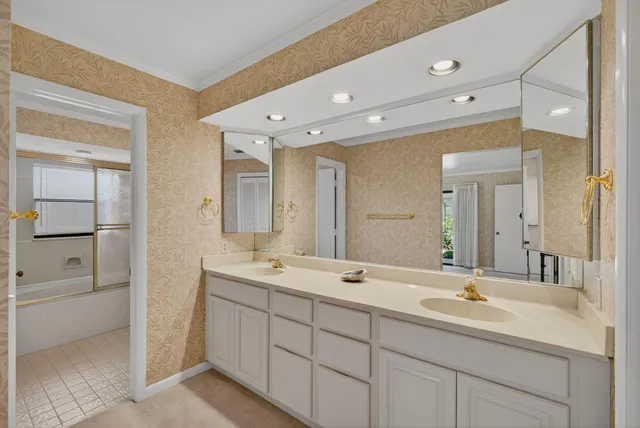 a spacious bathroom with a double vanity sink mirror and double