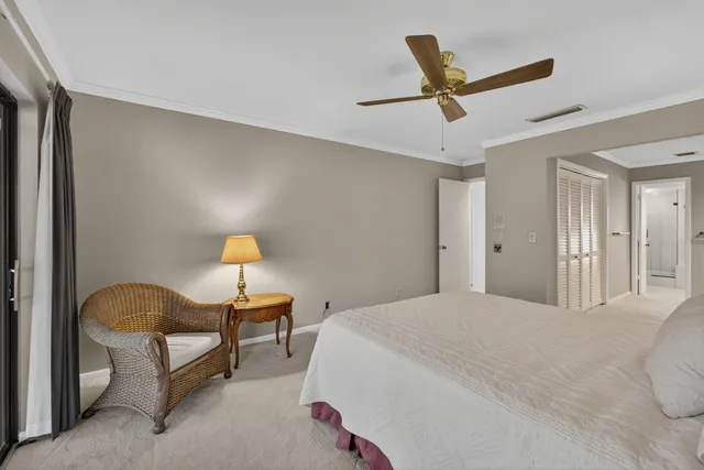 a bedroom with a bed and a ceiling fan