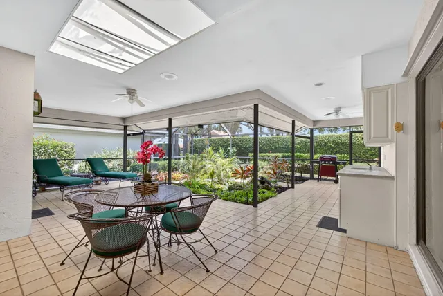 a dining room with furniture and a floor to ceiling window