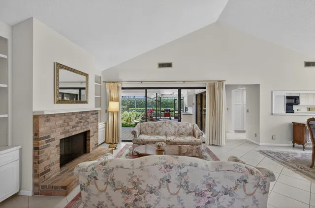 a large bedroom with a large bed and a fireplace with outer view