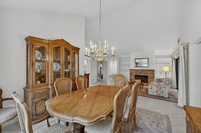 a view of a dining room with furniture and a chandelier