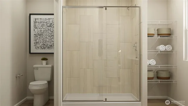 a bathroom with a shower a toilet and sink