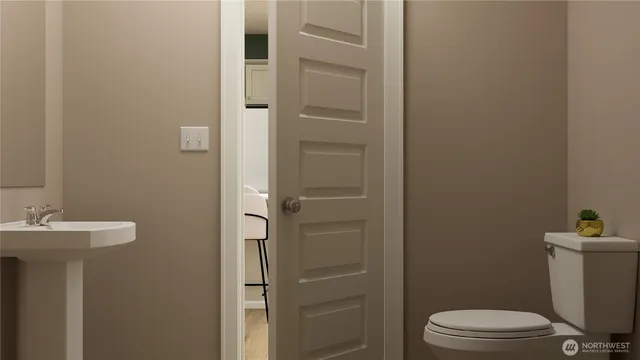 a bathroom with a sink mirror and toilet
