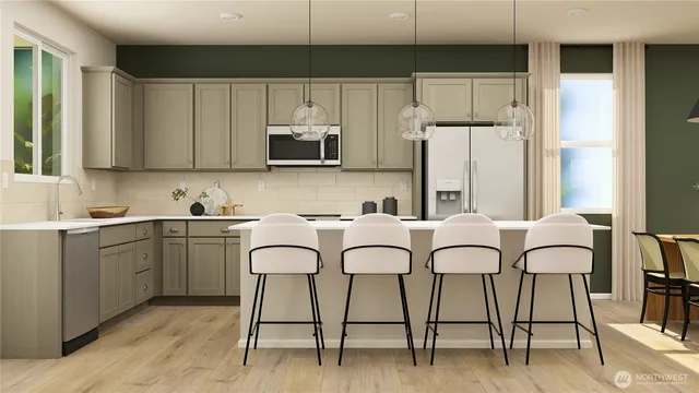 a kitchen with stainless steel appliances granite countertop a table chairs microwave and sink