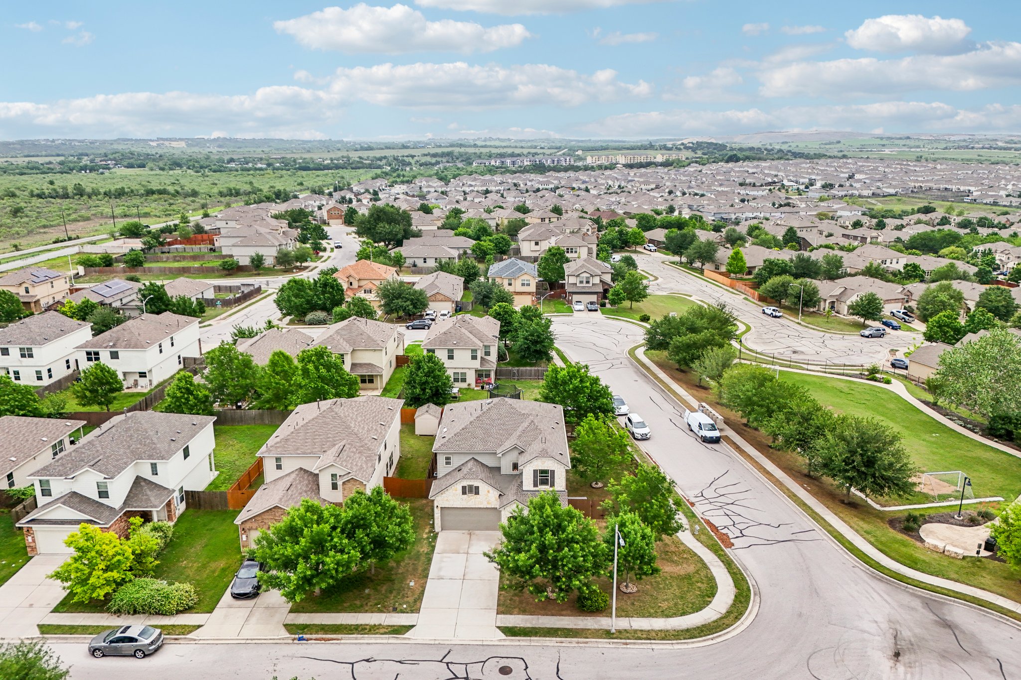 10033 Gertrudis Loop Austin, TX 78747 - Photo 36 of 39 Expansive aerial view showcasing a well-established residential area with numerous properties, each featuring a private driveway and green landscaping
