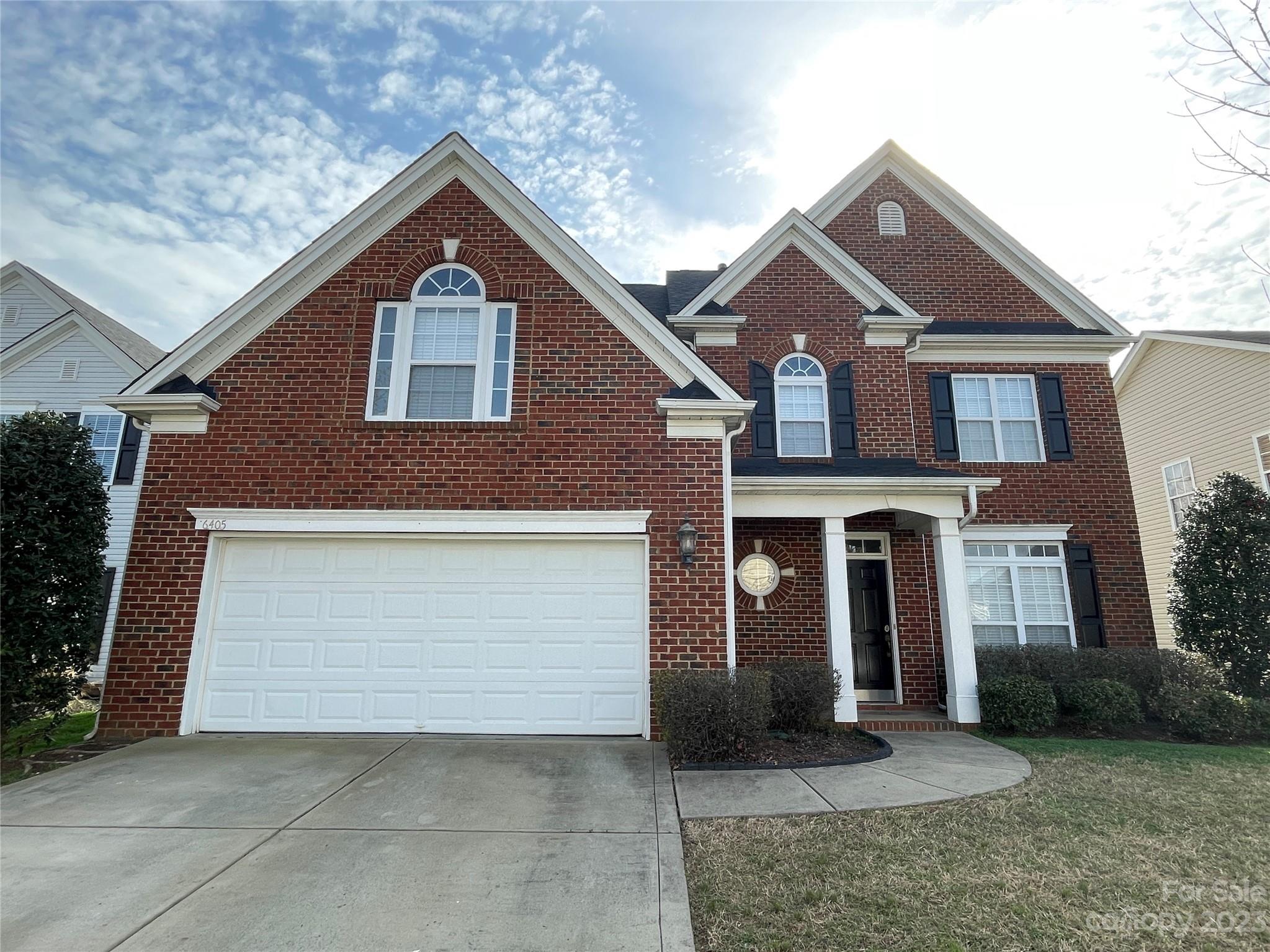 6405 Baltray Road Charlotte, NC 28278 - Photo 1 of 14 a front view of a house with a yard and garage