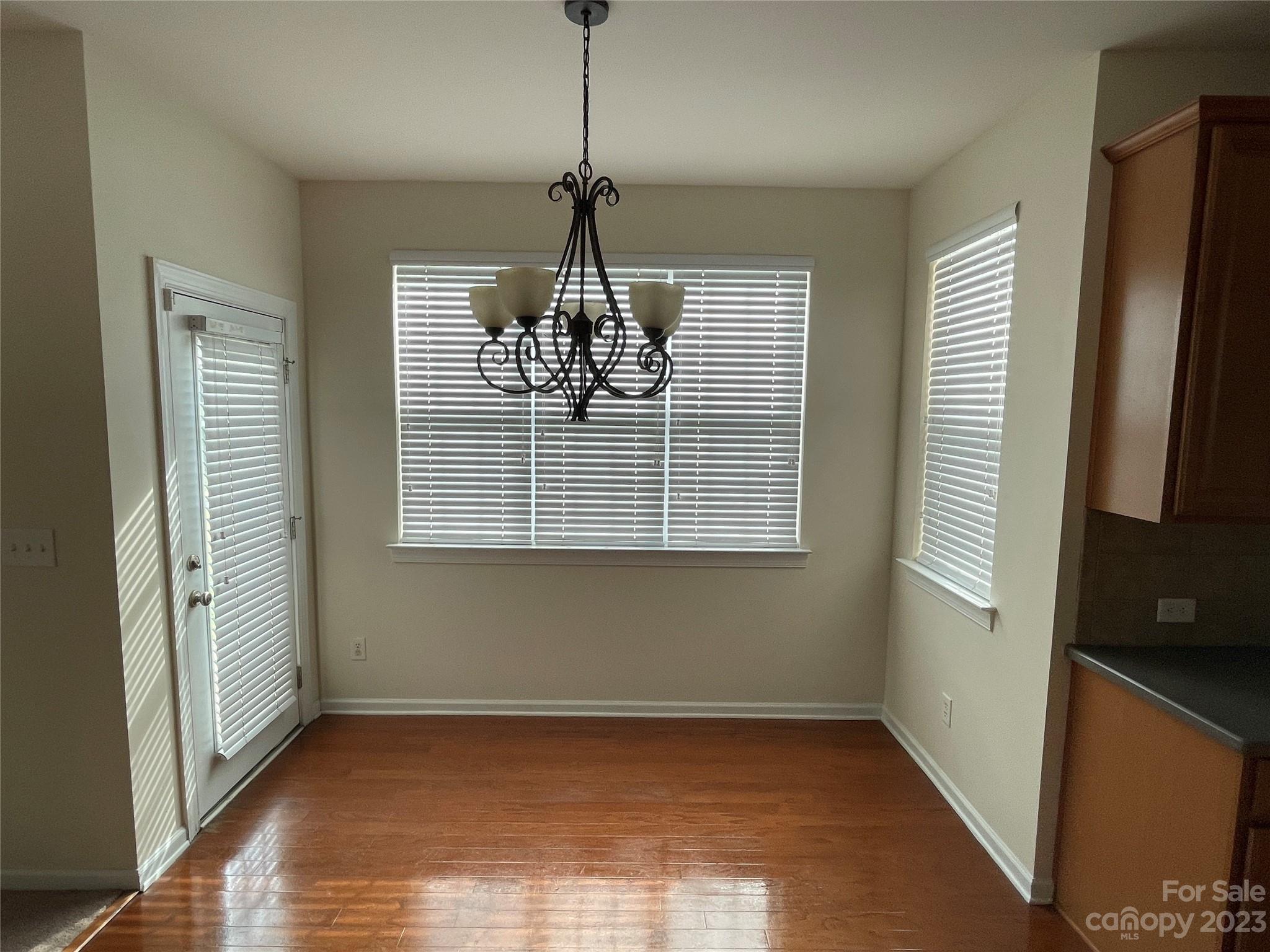 6405 Baltray Road Charlotte, NC 28278 - Photo 3 of 14 a view of empty room with wooden floor and fan