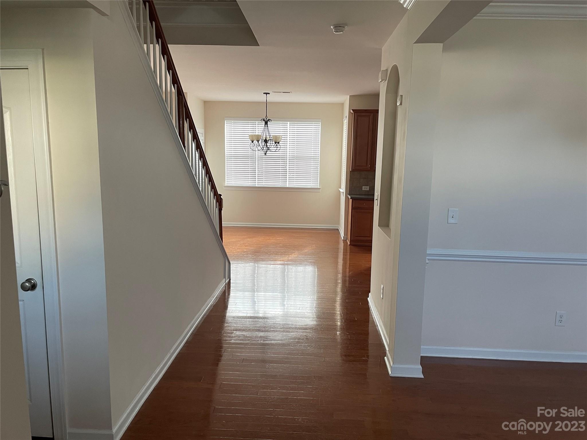 6405 Baltray Road Charlotte, NC 28278 - Photo 5 of 14 a view of a hallway with wooden floor and staircase