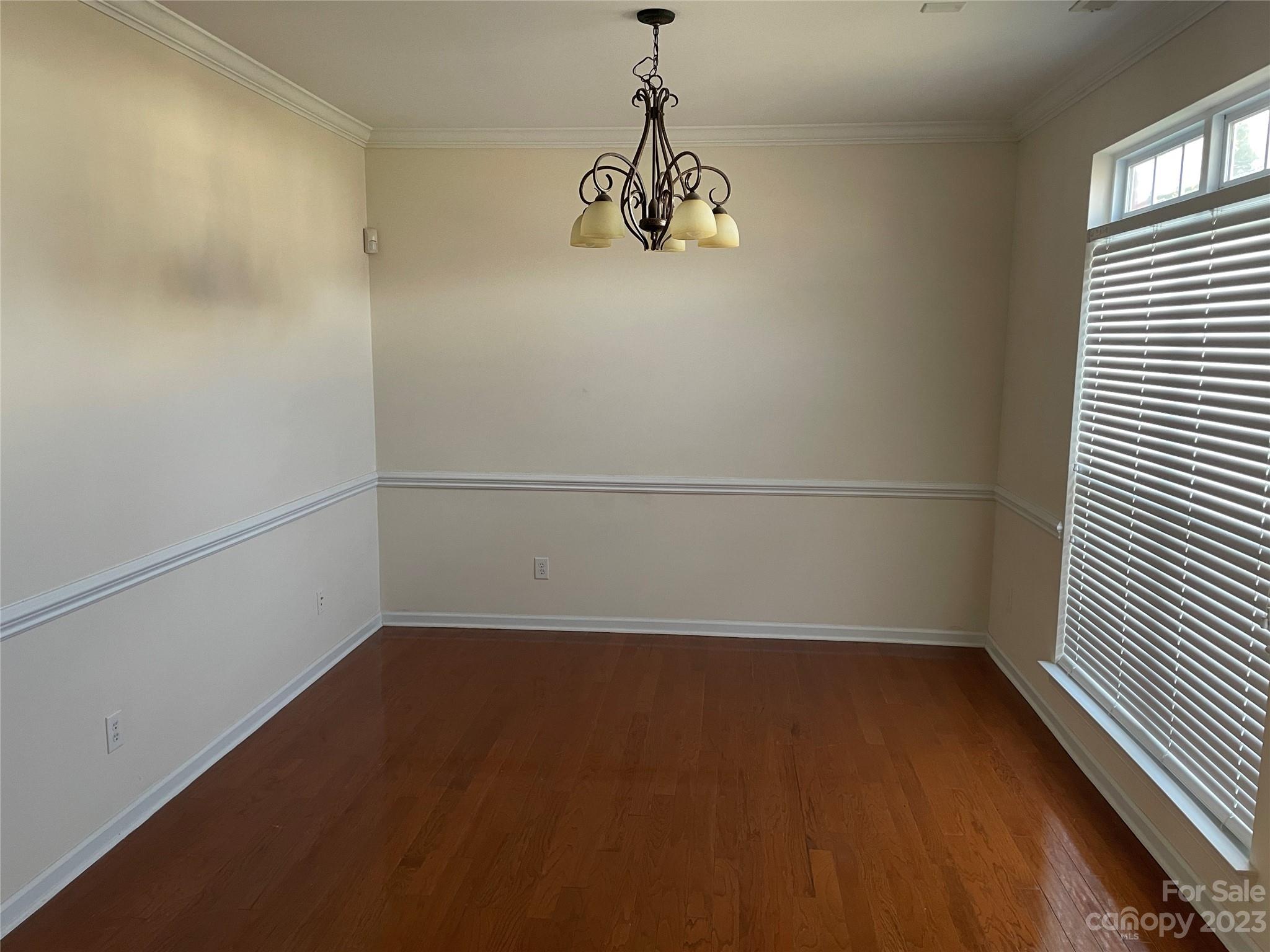 6405 Baltray Road Charlotte, NC 28278 - Photo 6 of 14 a view of a room with wooden floor and windows