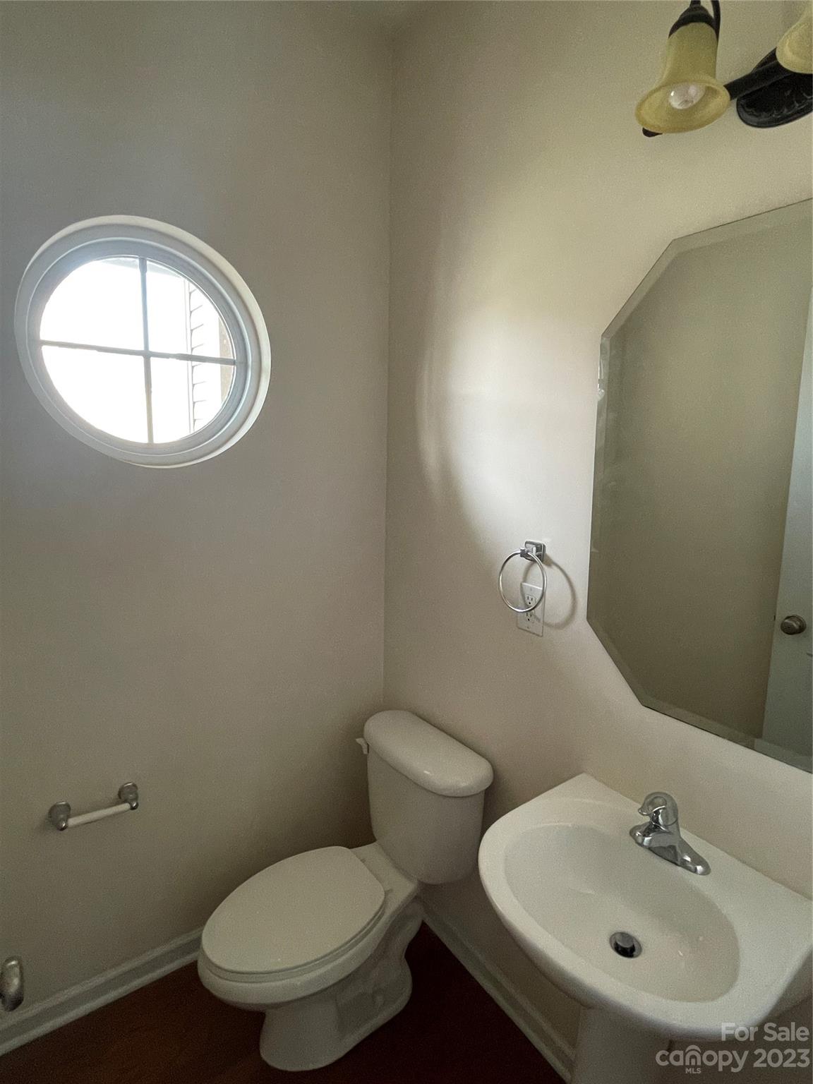 6405 Baltray Road Charlotte, NC 28278 - Photo 7 of 14 a bathroom with a toilet sink and mirror