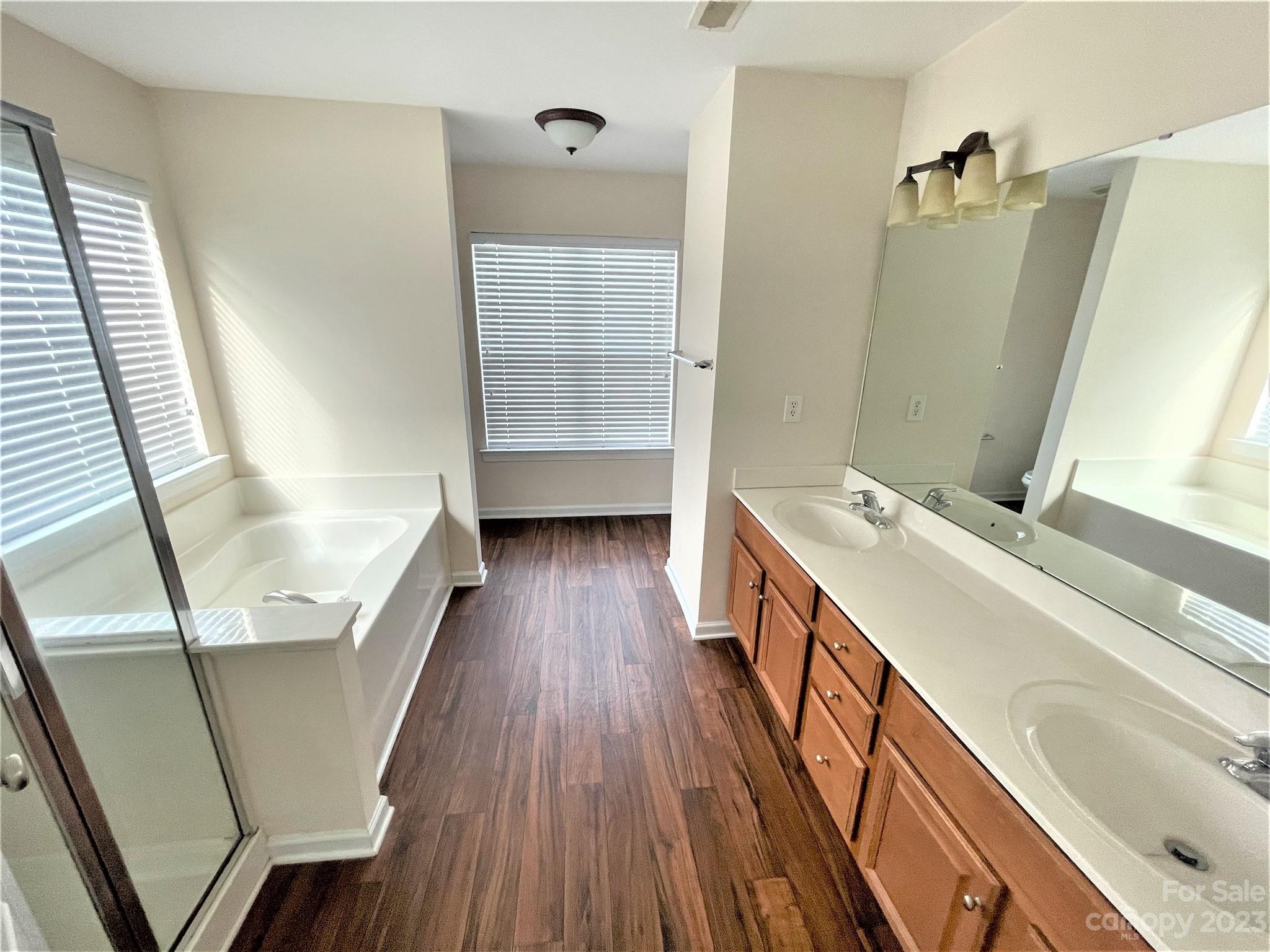 6405 Baltray Road Charlotte, NC 28278 - Photo 9 of 14 a bathroom with a sink a mirror and a bathtub