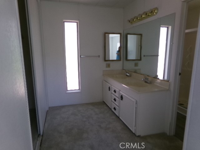 324 Ridgecrest Parkway Oroville, CA 95966 - Photo 11 of 33 a bathroom with a granite countertop sink and mirror with window