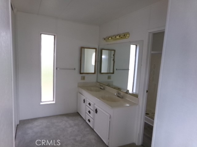 324 Ridgecrest Parkway Oroville, CA 95966 - Photo 20 of 33 a bathroom with a granite countertop sink and a mirror