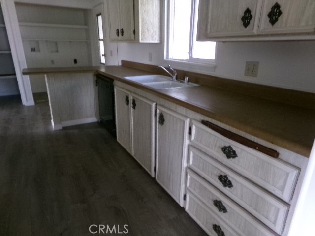 324 Ridgecrest Parkway Oroville, CA 95966 - Photo 27 of 33 a kitchen with granite countertop white cabinets and a sink
