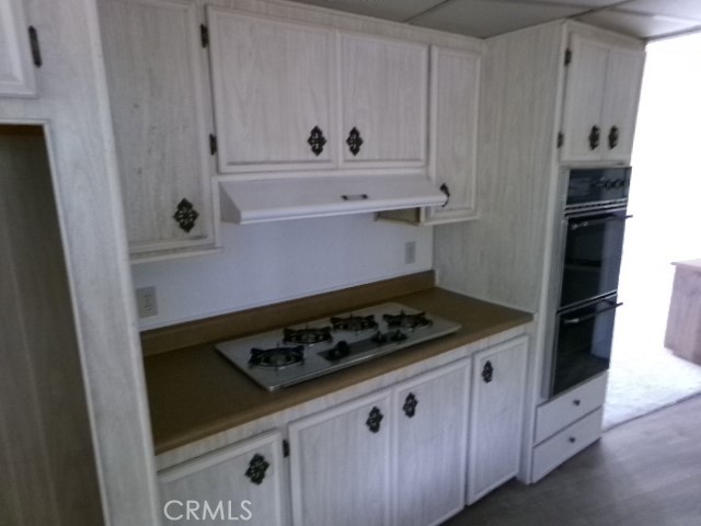 324 Ridgecrest Parkway Oroville, CA 95966 - Photo 29 of 33 a kitchen with white cabinets and appliances