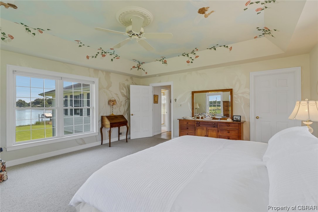 43 Locksley Court Reedville, VA 22539 - Photo 13 of 37 Bedroom with light carpet, a tray ceiling, and ceiling fan