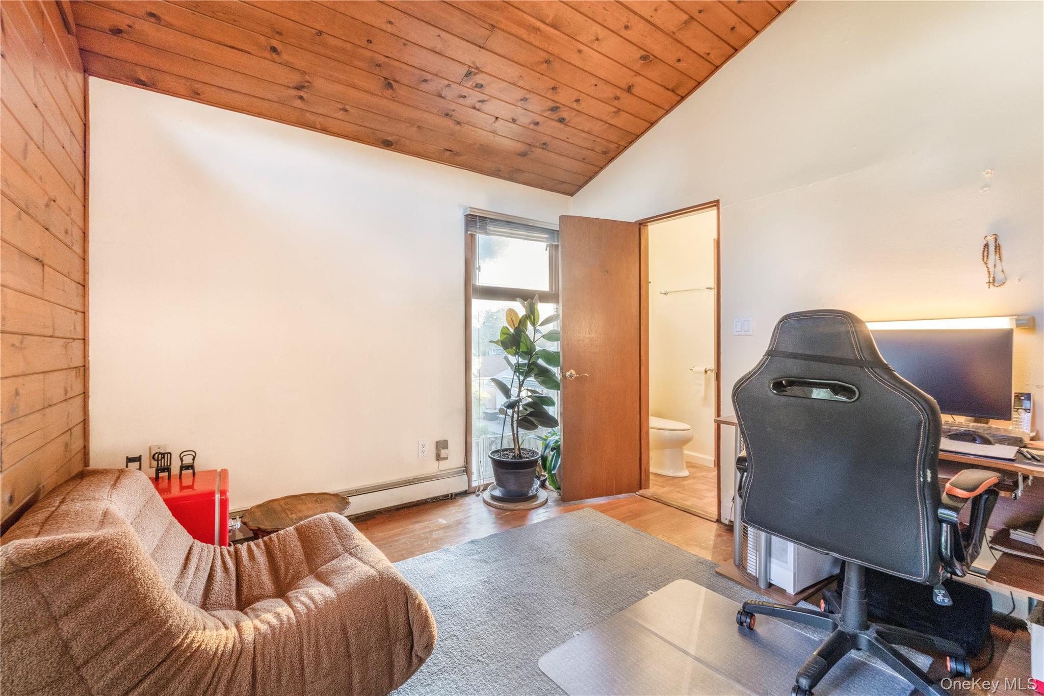 78 Joyce Road Plainview, NY 11803 - Photo 13 of 23 a living room with furniture and a flat screen tv