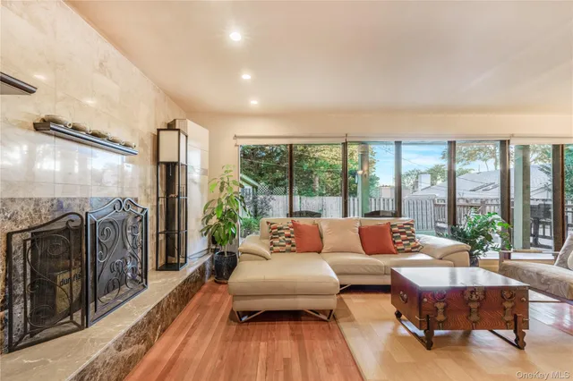 a living room with furniture and a floor to ceiling window