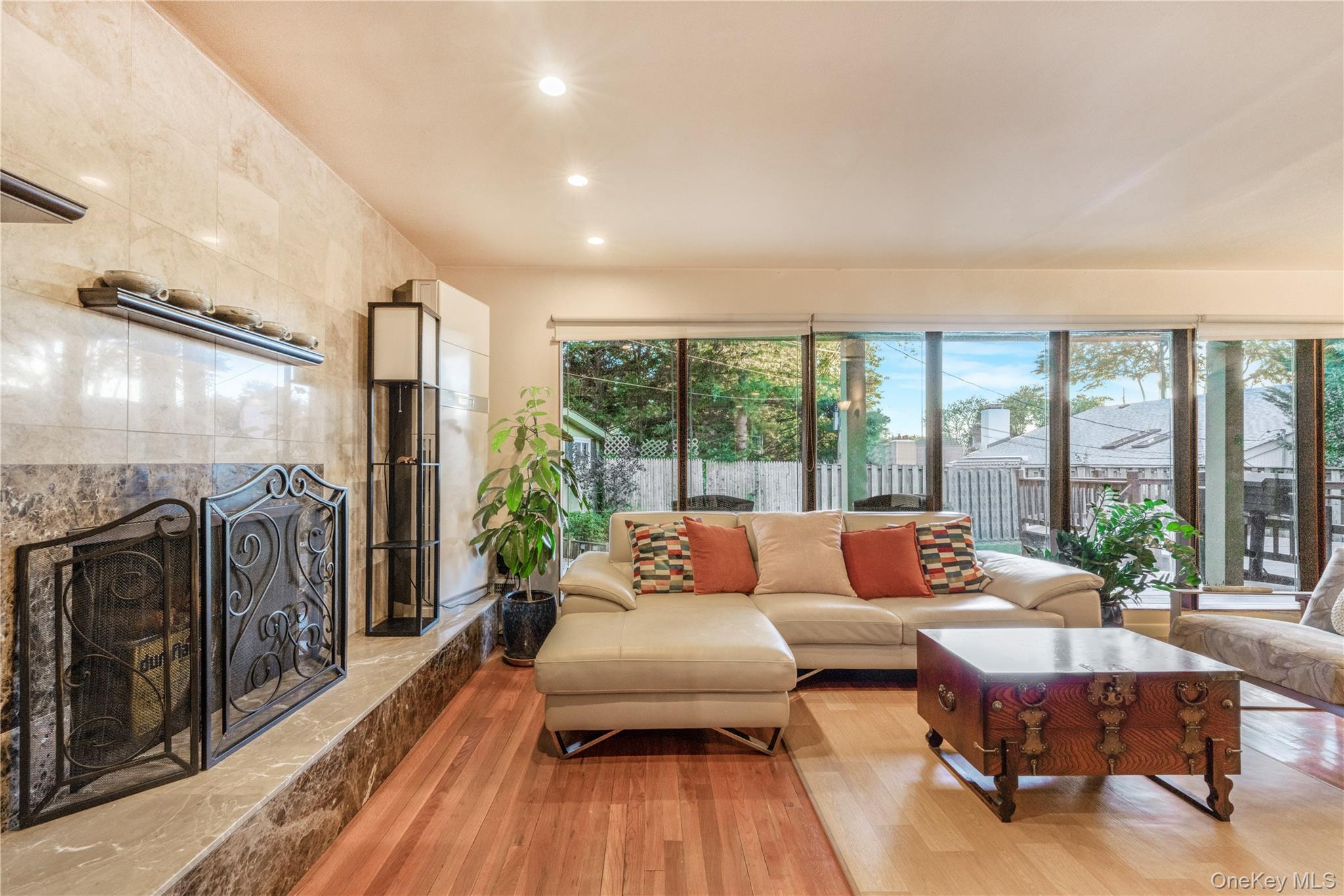 78 Joyce Road Plainview, NY 11803 - Photo 3 of 23 a living room with furniture and a floor to ceiling window