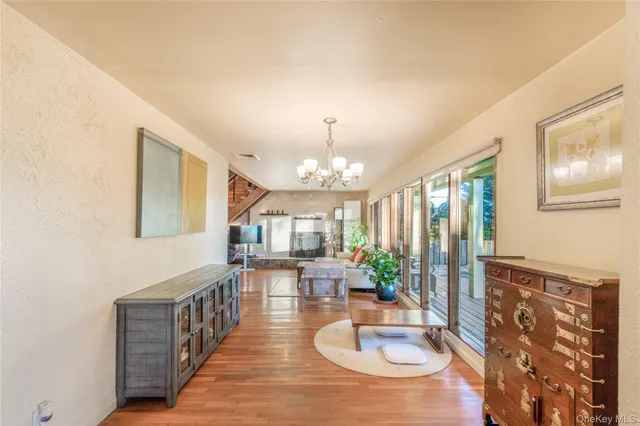 a dining room with furniture a chandelier and wooden floor