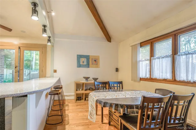 a view of a dining room with furniture window and wooden floor