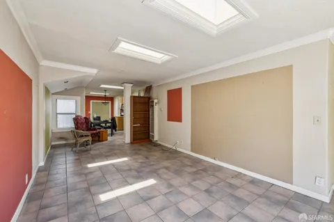a view of a hallway with wooden floor and entryway