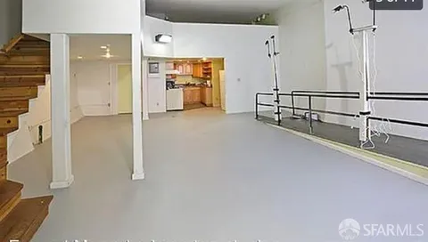 a view of a room with wooden floor and cabinets