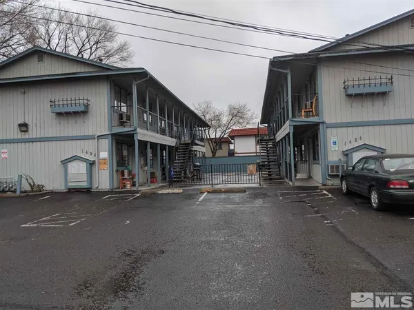 a couple of cars parked in front of a house