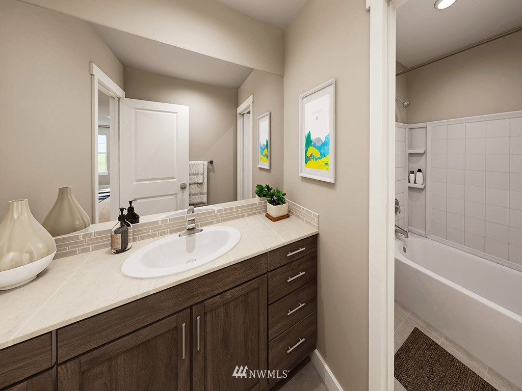 11 181st Street Southeast, Unit 17 Bothell, WA 98012 - Photo 23 of 32 a bathroom with a sink double vanity granite tub shower and a mirror