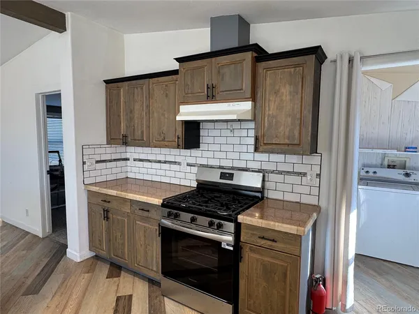 a kitchen with stainless steel appliances a stove sink and cabinets