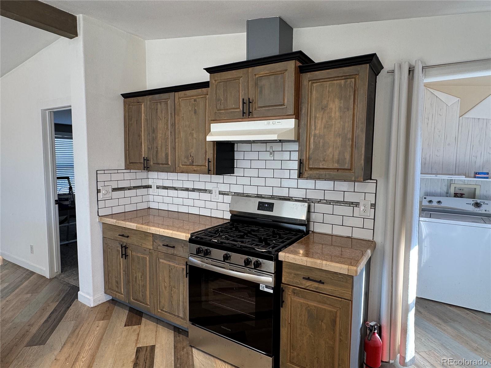 620 Falling Rock Road Cotopaxi, CO 81223 - Photo 6 of 32 a kitchen with stainless steel appliances a stove sink and cabinets