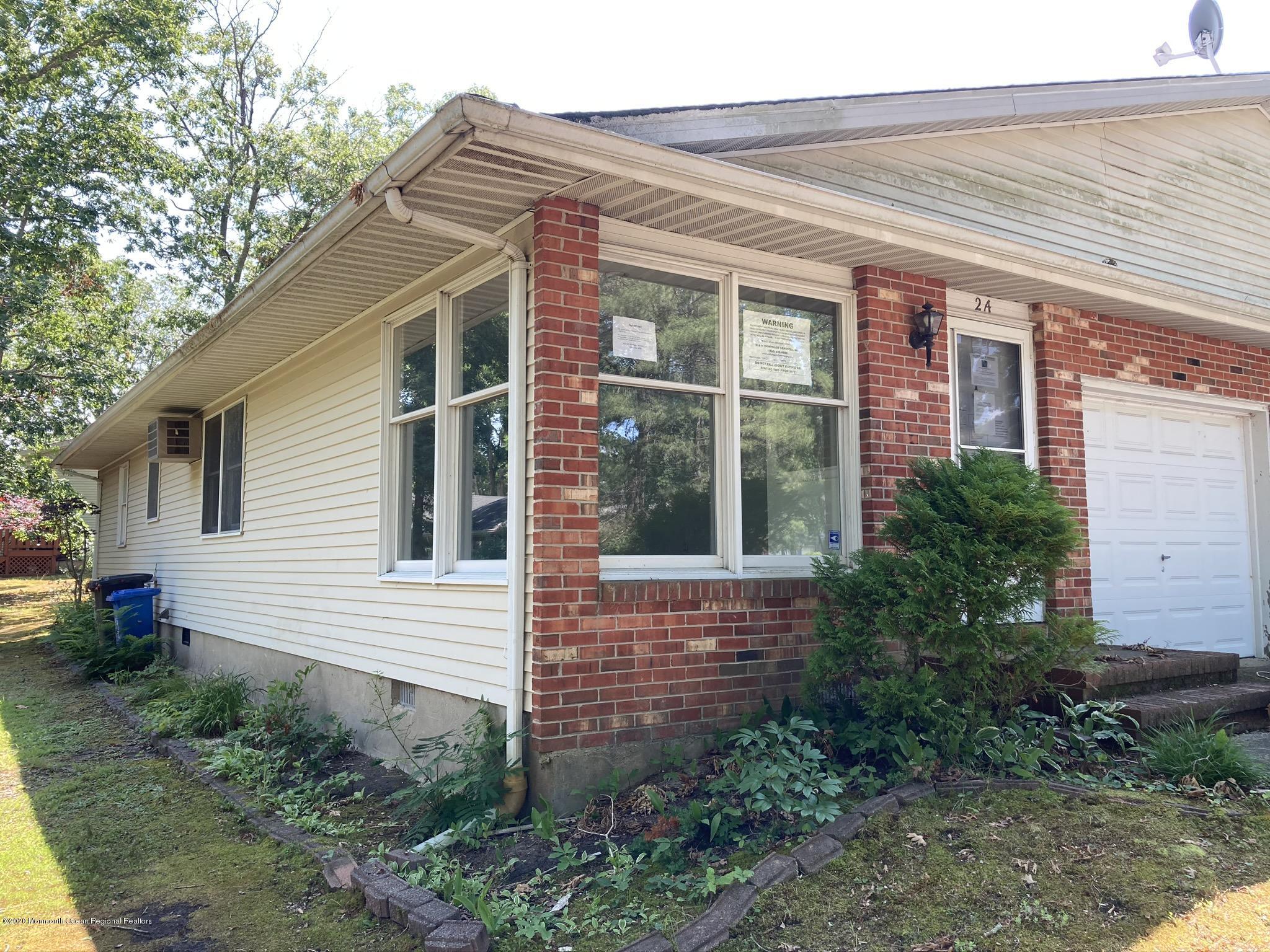 2B Magnolia Road, Unit A Manahawkin, NJ 08050 - Photo 2 of 19 a front view of a house with garden