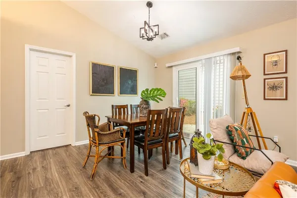 a view of a dining room with furniture window and wooden floor