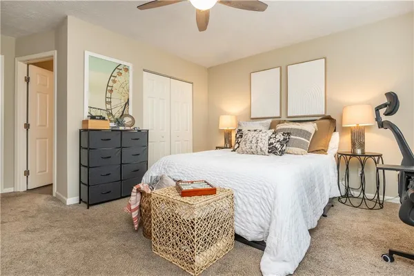 a bedroom with a bed and a chandelier