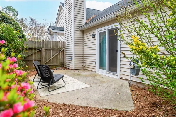 a view of backyard with a potted plant ana a small yard