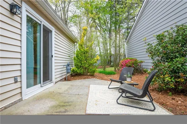 a view of a chair and table in backyard of the house