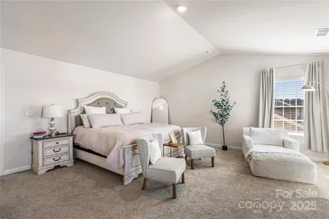 a spacious bedroom with a bed and a couch