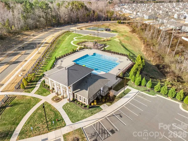 a view of swimming pool with outdoor seating and plants